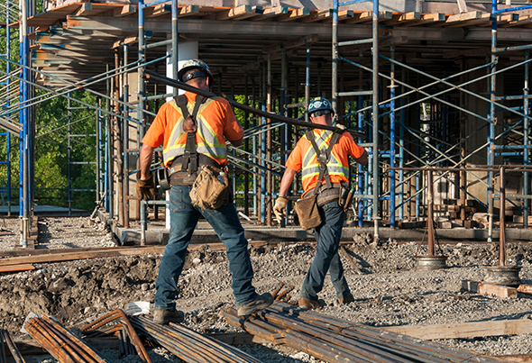 Union employees carrying a pipe