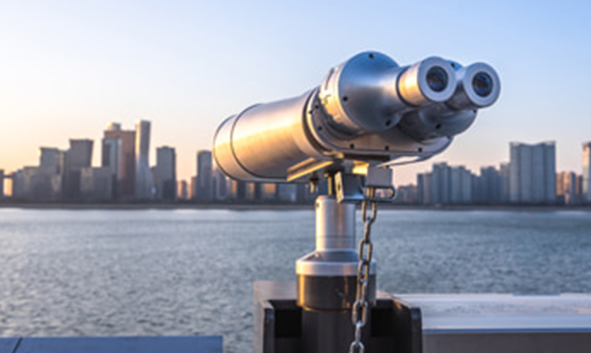 viewing scope overlooking city skyline and bay