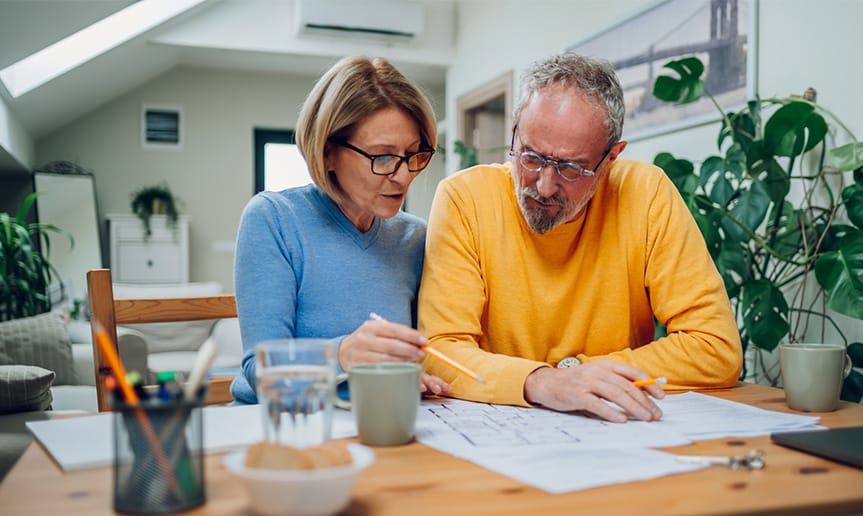 A man and woman looking at paperwork.