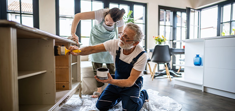 People painting kitchen cabinets