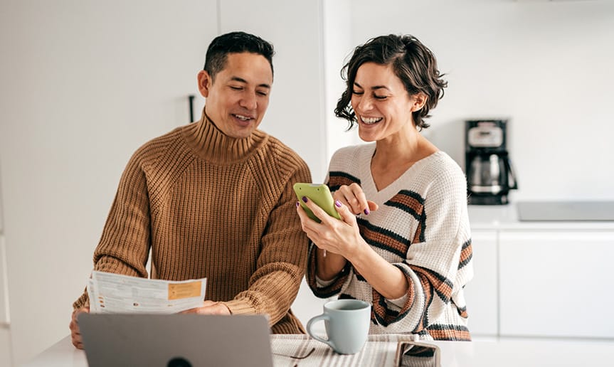 A woman and man looking at phone.