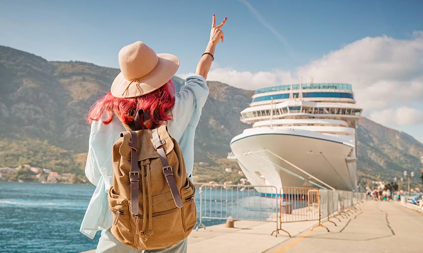 A women waving at a cruise ship.