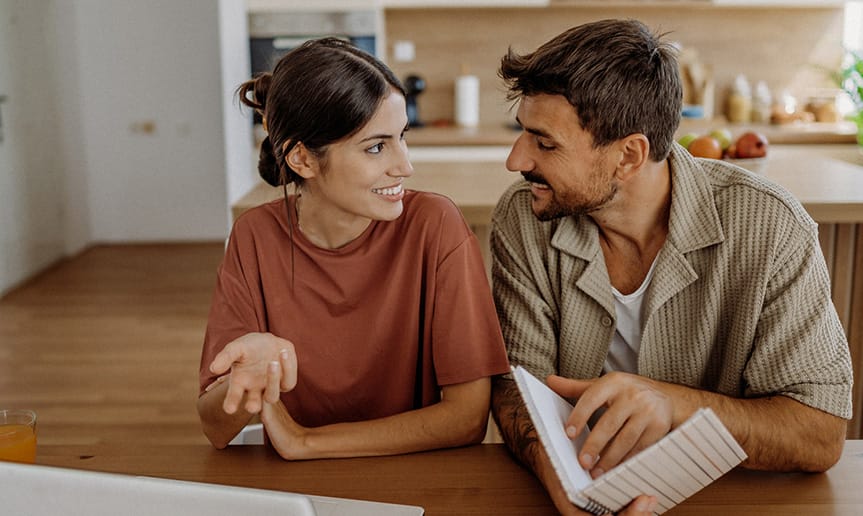 A man and woman looking at notes.